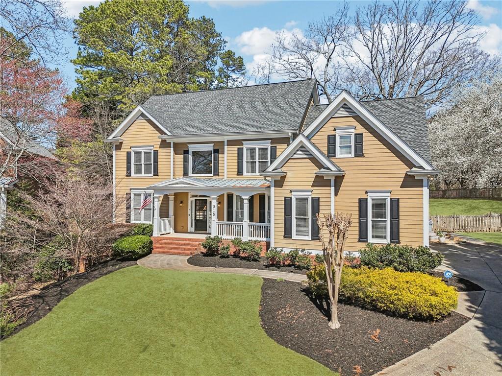 315 Riley View Ct, Alpharetta, GA 30004 - view of front of home with a porch, fence, a front lawn, and roof with shingles