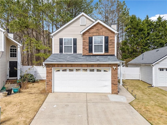 traditional home with brick siding, driveway, roof with shingles, and fence