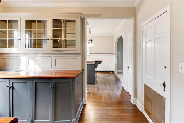 hall featuring ornamental molding and dark hardwood / wood-style floors