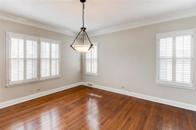 empty room with ornamental molding and dark hardwood / wood-style floors