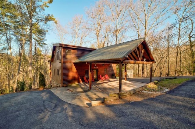 view of side of property featuring a carport