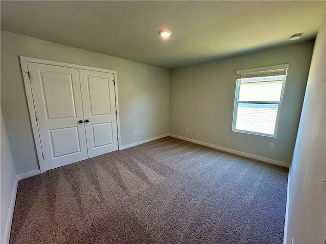 unfurnished bedroom featuring a closet and carpet