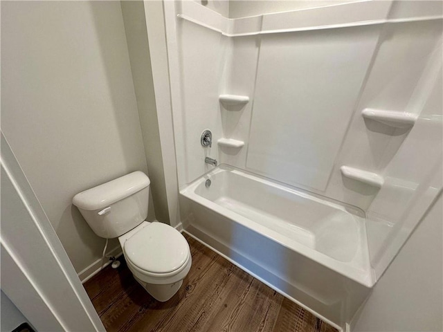 bathroom with toilet, tub / shower combination, and hardwood / wood-style floors