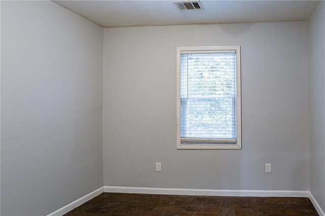 spare room with dark hardwood / wood-style floors