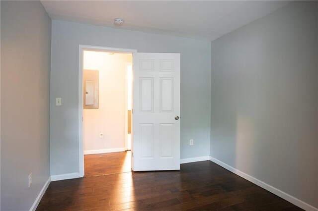 unfurnished room featuring dark wood-type flooring