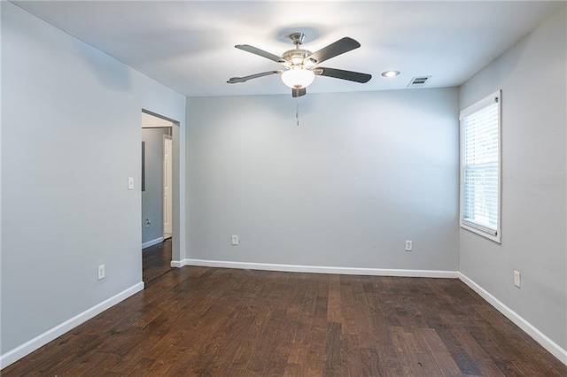 spare room with ceiling fan and dark hardwood / wood-style flooring