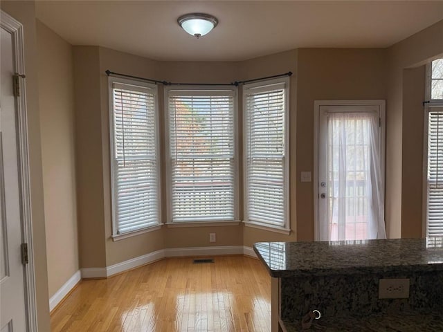 1919 Barrett Knoll Cir NW, Kennesaw, GA 30152 - unfurnished dining area featuring light wood-style floors and baseboards