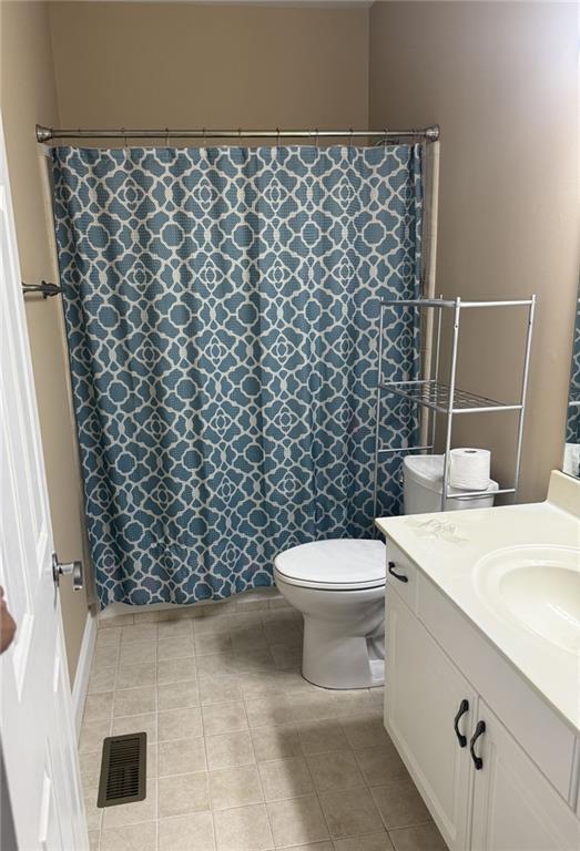 1919 Barrett Knoll Cir NW, Kennesaw, GA 30152 - bathroom with vanity, toilet, tile patterned flooring, and curtained shower