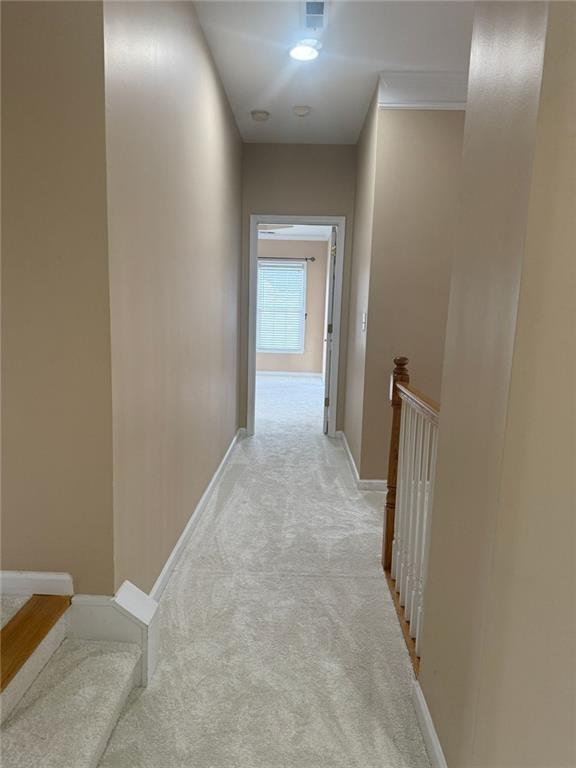 1919 Barrett Knoll Cir NW, Kennesaw, GA 30152 - hallway featuring light colored carpet, baseboards, and an upstairs landing