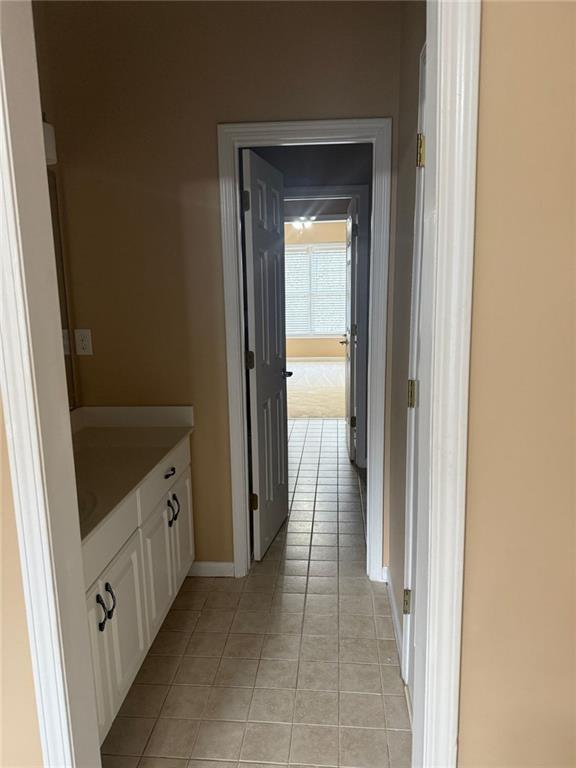 1919 Barrett Knoll Cir NW, Kennesaw, GA 30152 - hallway with light tile patterned floors and baseboards