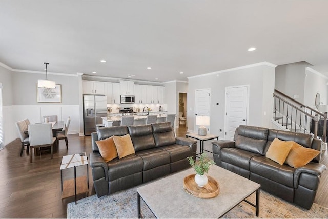 living area featuring stairs, dark wood-type flooring, recessed lighting, and crown molding