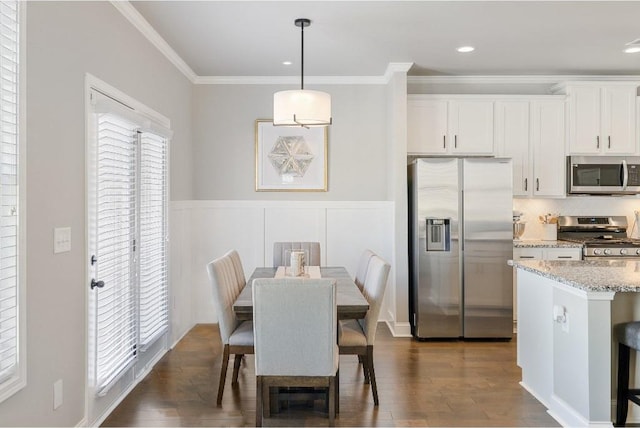 dining room featuring recessed lighting, ornamental molding, dark wood finished floors, and wainscoting