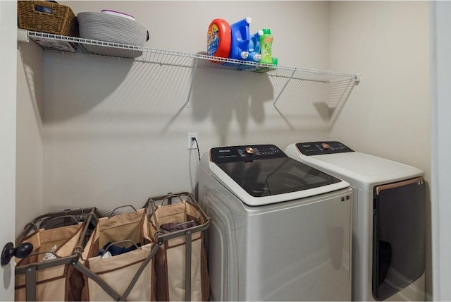 washroom featuring laundry area and washer and clothes dryer