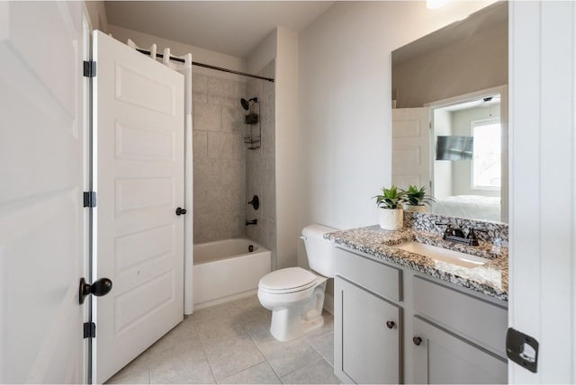 ensuite bathroom featuring shower / bathtub combination, toilet, vanity, ensuite bath, and tile patterned floors