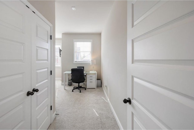 office area with baseboards and light colored carpet