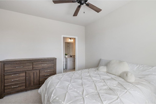 bedroom with a ceiling fan, light carpet, and ensuite bathroom