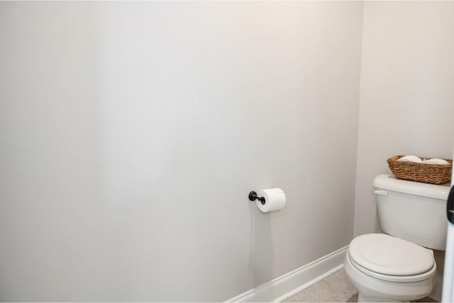 bathroom featuring tile patterned floors, toilet, and baseboards