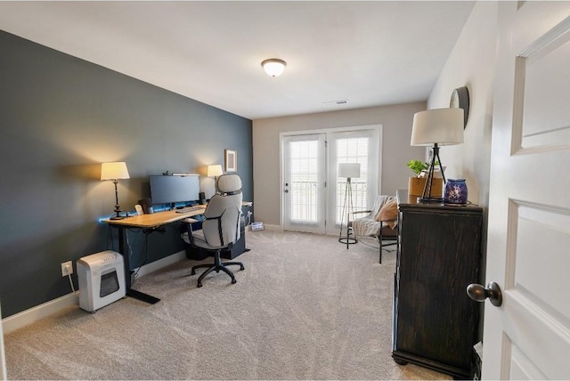 carpeted home office with visible vents and baseboards