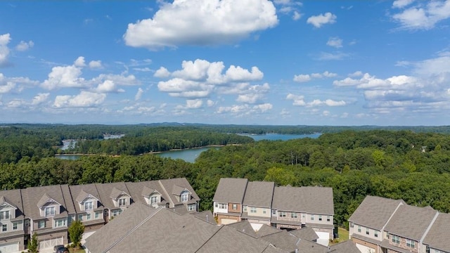 birds eye view of property with a water view, a residential view, and a view of trees