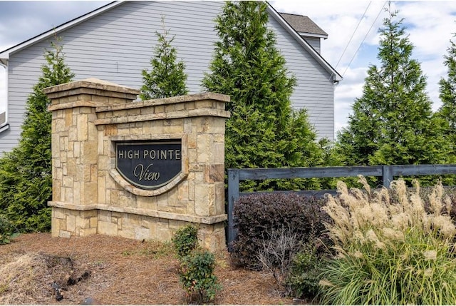 community sign featuring fence