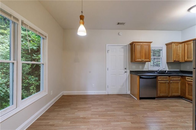 3135 Washington Rd, Atlanta, GA 30344 - kitchen featuring dishwasher, light wood-style flooring, brown cabinetry, and healthy amount of natural light