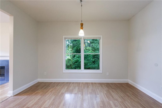 3135 Washington Rd, Atlanta, GA 30344 - empty room with light wood finished floors, baseboards, and a high end fireplace