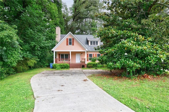 3135 Washington Rd, Atlanta, GA 30344 - view of front facade with covered porch, concrete driveway, a chimney, and a front yard