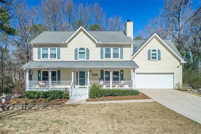 view of front facade featuring a chimney, a porch, a front yard, a garage, and driveway