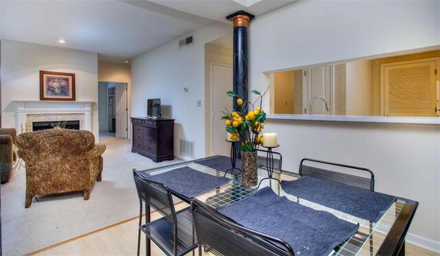 living room with light carpet and a fireplace