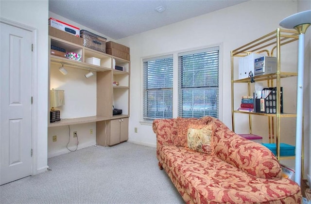 sitting room with light carpet and built in desk