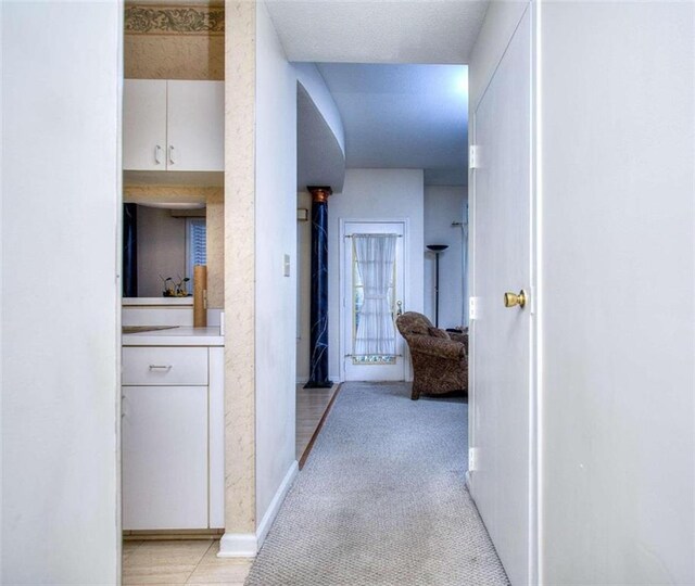 living area with ceiling fan, carpet floors, and a textured ceiling