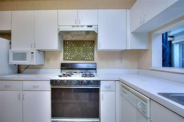 kitchen with white appliances, light countertops, under cabinet range hood, and white cabinetry