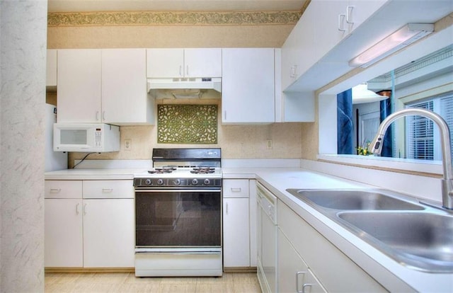 kitchen featuring light countertops, white cabinetry, a sink, white appliances, and under cabinet range hood