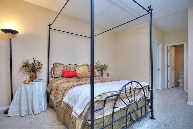 carpeted bedroom featuring baseboards