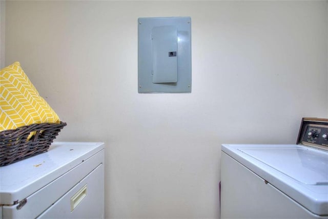 washroom with laundry area, independent washer and dryer, and electric panel