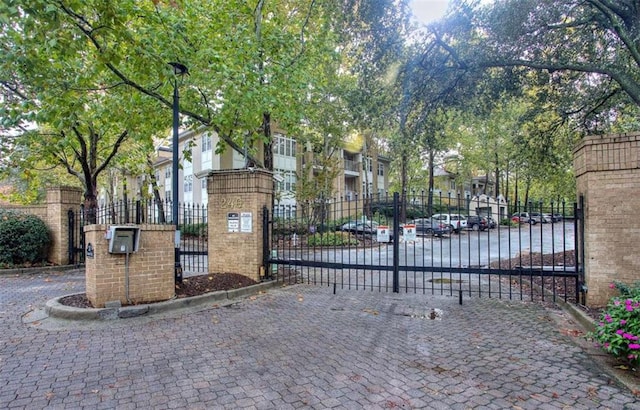 view of gate featuring a residential view and fence