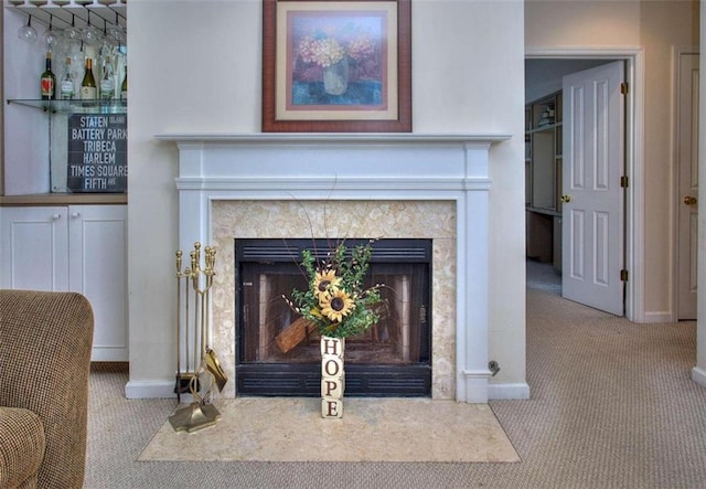 details with a fireplace, carpet flooring, and baseboards