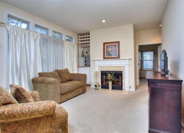 carpeted living area featuring a fireplace with flush hearth, a wealth of natural light, and recessed lighting