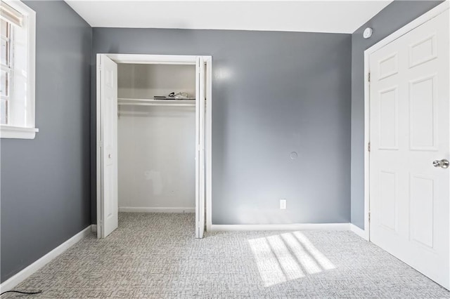 unfurnished bedroom featuring carpet flooring and a closet