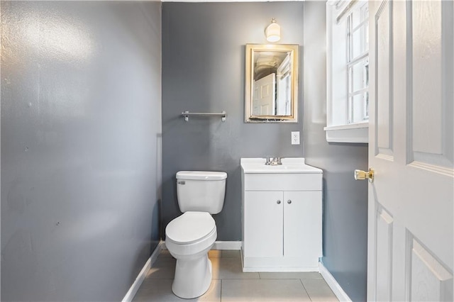 bathroom with tile patterned flooring, vanity, and toilet