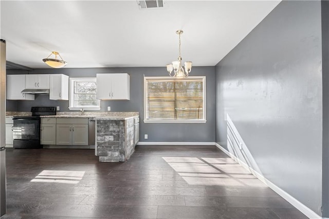 kitchen featuring sink, decorative light fixtures, dark hardwood / wood-style flooring, black range with electric stovetop, and white cabinets