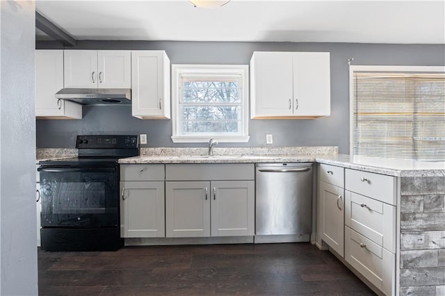 kitchen featuring dishwasher, black electric range oven, sink, white cabinets, and dark hardwood / wood-style flooring