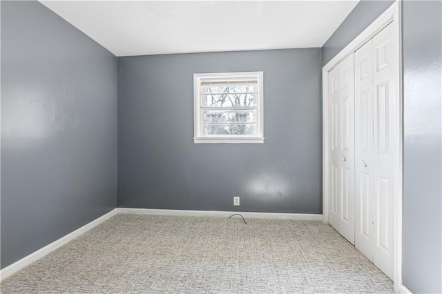 unfurnished bedroom featuring a closet and carpet