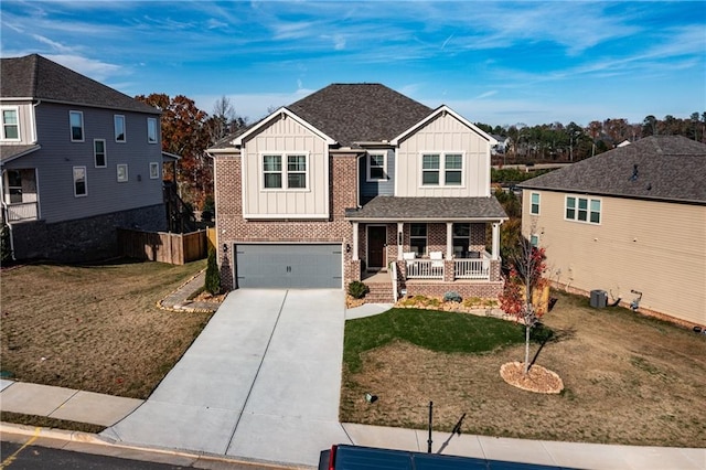 view of front of home with a porch, a garage, and a front lawn