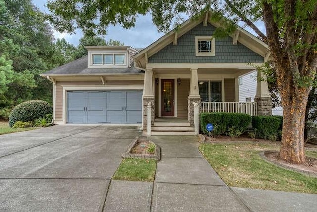 craftsman inspired home with a garage and a porch