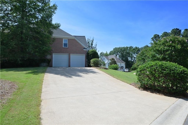 3071 Intrepid Wake, Marietta, GA 30062 - view of front of house featuring concrete driveway, a front yard, brick siding, and an attached garage