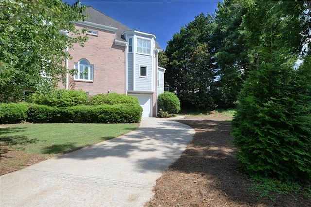 3071 Intrepid Wake, Marietta, GA 30062 - view of side of property with concrete driveway, brick siding, a yard, and a garage