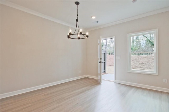 unfurnished room with visible vents, wood finished floors, crown molding, baseboards, and a chandelier