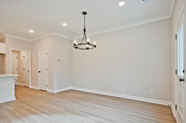 spare room with an inviting chandelier, baseboards, light wood-style floors, and ornamental molding