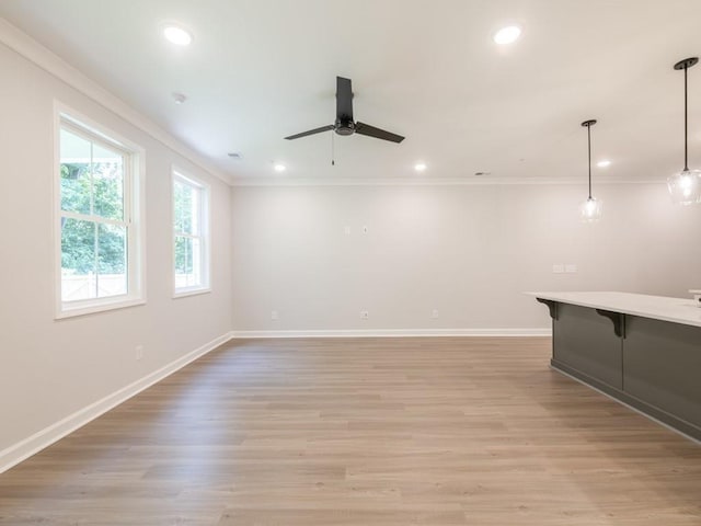 spare room featuring ceiling fan, light hardwood / wood-style floors, and crown molding